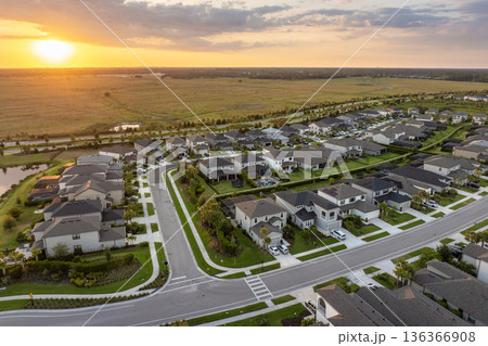 Expensive mansions between green palm trees in southwest Florida suburbs, USA. Aerial view of wealthy residential neighborhood Expensive mansions between green palm trees in southwest Florida suburbs, USA. Aerial view of wealthy residential neighborhood 136366908