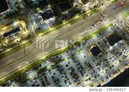 Strip mall plaza in North Port, Florida with illuminated traffic driving cars. USA transportation infrastructure concept 136366927