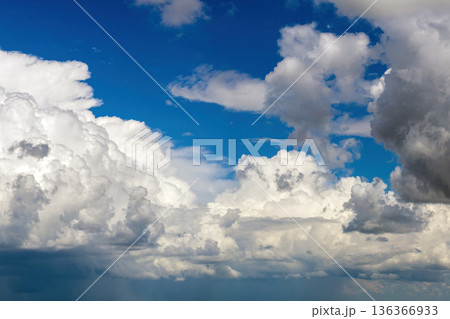 Blue sky with white summer rain clouds. Colorful summer landscape Blue sky with white summer rain clouds. Colorful summer landscape 136366933