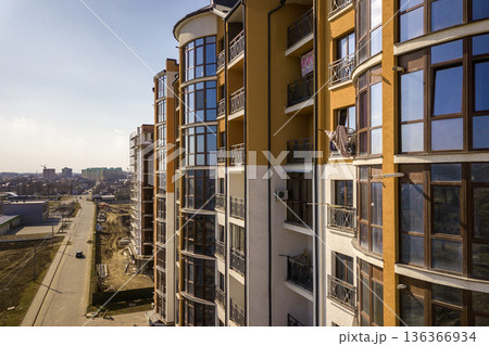 New tall apartment buildings and parked cars and suburb houses on blue sky copy space background. 136366934