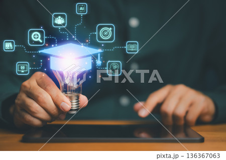 Innovative concept of digital education showing a hand holding a glowing light bulb with graduation cap and learning icons, symbolizing e-learning, creativity, and modern knowledge technology. Innovative concept of digital education showing a hand holding a glowing light bulb with graduation cap and learning icons, symbolizing e-learning, creativity, and modern knowledge technology. 136367063
