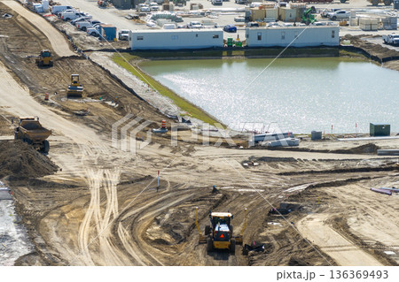 Roadworks construction site on American highway. Development of city transportation crossroads Roadworks construction site on American highway. Development of city transportation crossroads 136369493