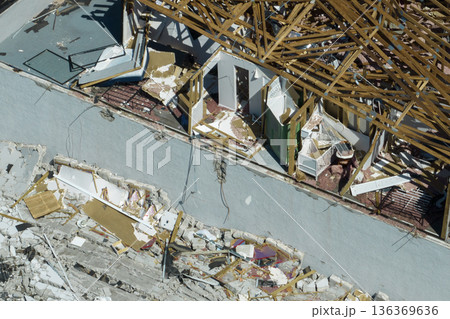 Natural disaster and its consequences. Hurricane Ian destroyed house roof and walls in Florida residential area Natural disaster and its consequences. Hurricane Ian destroyed house roof and walls in Florida residential area 136369636