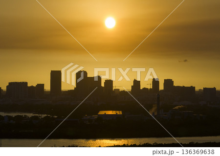 Aerial view of downtown district of Tampa city in Florida, USA at sunset. Dark silhouette of high skyscraper office buildings in modern american midtown 136369638