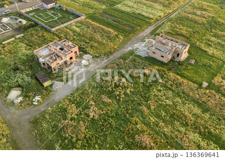 Aerial view of building site for future house, brick basement floor and stacks of brick for construction. 136369641