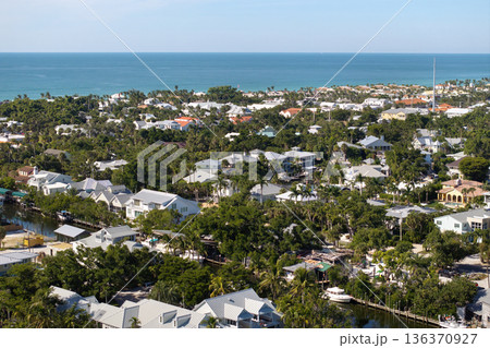 Premium housing development in the USA. Expensive waterfront houses between green palm trees in Boca Grande, small town on Gasparilla Island in southwest Florida 136370927