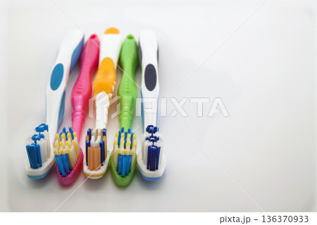 Colorful toothbrushes on white background with copy space. Macro with shallow dof. 136370933