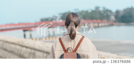 Woman tourist sightseeing Fukuura jima bridge or the bridge of romantic encounters for Fukuura Island at Matsushima Bay in Matsushima, Miyagi Prefecture, Tohoku, Japan. Landmark and famous Vacation 136376886