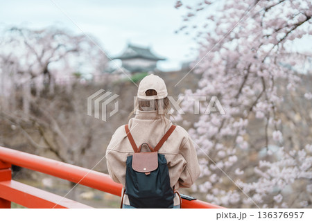 Woman tourist sightseeing Hirosaki Castle with Sakura Cherry Blossom in Spring, happy traveler travel in Hirosaki city, Aomori, Tohoku, Japan. Landmark famous in Japan. Travel and Vacation destination Woman tourist sightseeing Hirosaki Castle with Sakura Cherry Blossom in Spring, happy traveler travel in Hirosaki city, Aomori, Tohoku, Japan. Landmark famous in Japan. Travel and Vacation destination 136376957
