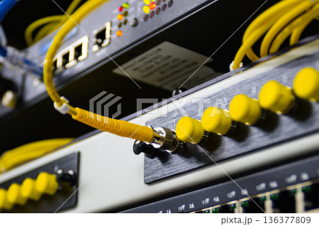 Close up of network switch with yellow ethernet cables connected, server room equipment Close up of network switch with yellow ethernet cables connected, server room equipment 136377809