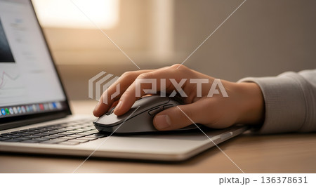 Close up hand using computer mouse on laptop keyboard for productive work or browsing Close up hand using computer mouse on laptop keyboard for productive work or browsing 136378631