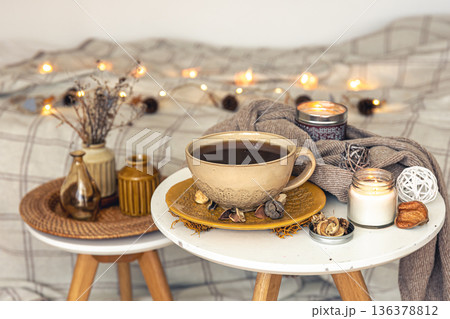 Cozy autumn composition with a cup of tea and decorative details. Cozy autumn composition with a cup of tea and decorative details. 136378812