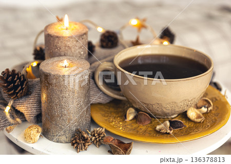Cozy autumn composition with a cup of tea and decorative details. 136378813
