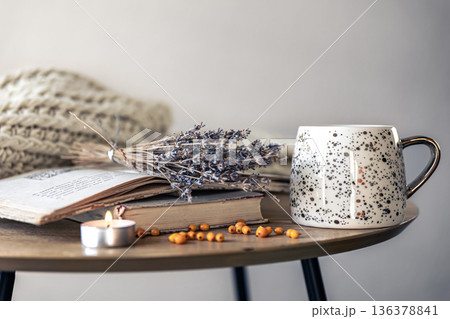 Cozy home composition with a cup, books and dried lavender flowers. Cozy home composition with a cup, books and dried lavender flowers. 136378841