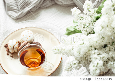 Cozy spring composition with tea and blooming lilac. Cozy spring composition with tea and blooming lilac. 136378849