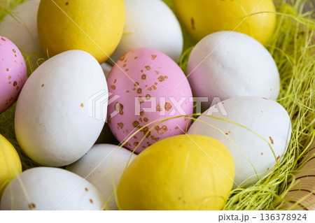 Easter composition with eggs in a decorative nest, close up. Easter composition with eggs in a decorative nest, close up. 136378924