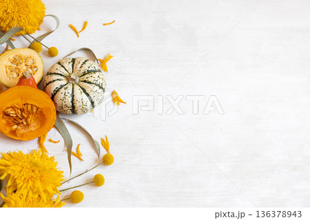 Autumn flat lay background with pumpkins and flowers, copy space. Autumn flat lay background with pumpkins and flowers, copy space. 136378943