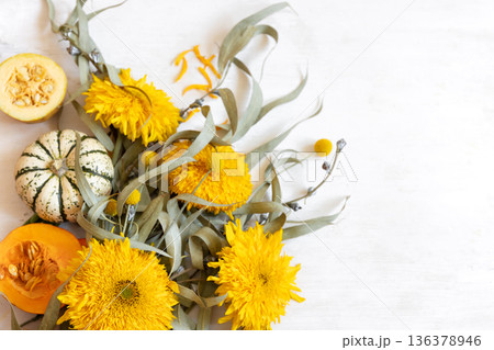 Autumn festive composition with flowers and pumpkins on a white background. 136378946