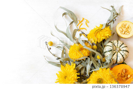 Autumn festive composition with flowers and pumpkins on a white background. 136378947