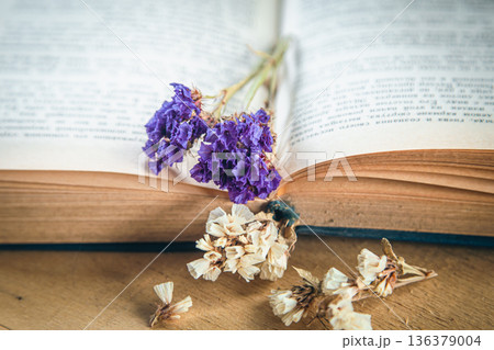 Flower of colorful dried flowers on an open book, close-up. Flower of colorful dried flowers on an open book, close-up. 136379004