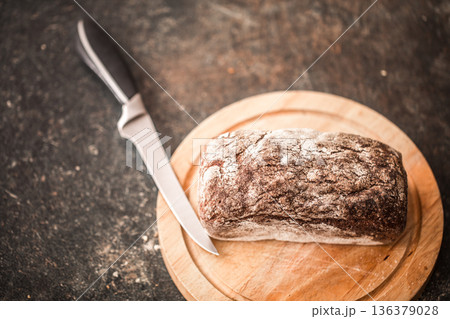 fresh bread in hands closeup on old wooden background 136379028