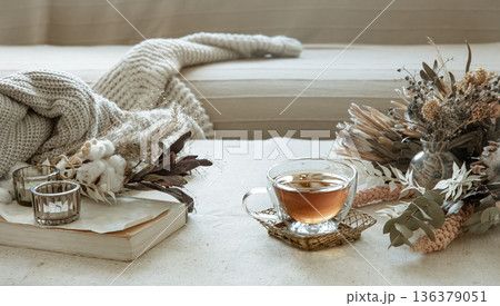 Cozy composition with a cup of tea, dried flowers and decorative elements. 136379051