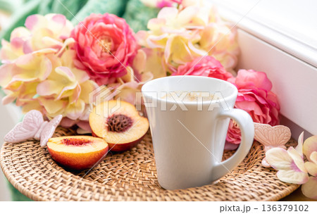 Home composition with a cup of coffee, flowers and a knitted element. Home composition with a cup of coffee, flowers and a knitted element. 136379102