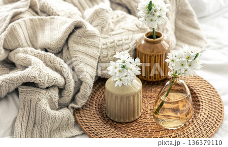 Home composition with flowers in vases and a knitted element. Home composition with flowers in vases and a knitted element. 136379110