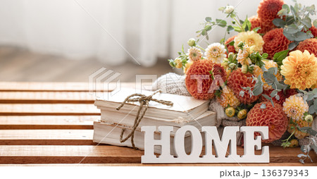 Autumn composition with a bouquet of chrysanthemums and decorative word home. 136379343