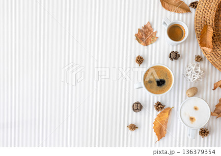 Autumn composition with cups of coffee and leaves on a white background. Autumn composition with cups of coffee and leaves on a white background. 136379354