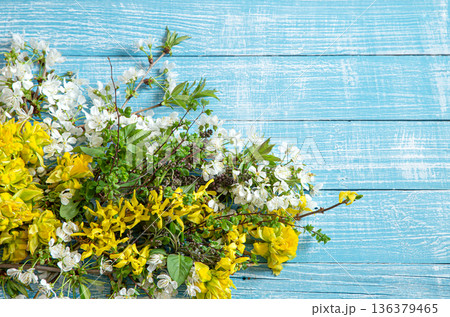 Beautiful spring flowers and blooms on a wooden background. Beautiful spring flowers and blooms on a wooden background. 136379465