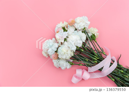 Bouquet of white carnations on a pink background isolated, flat lay. 136379550