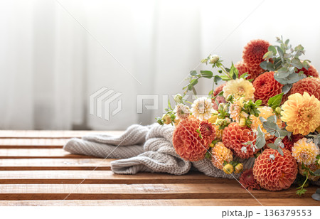 A bouquet of yellow and orange chrysanthemums on a blurred background. 136379553