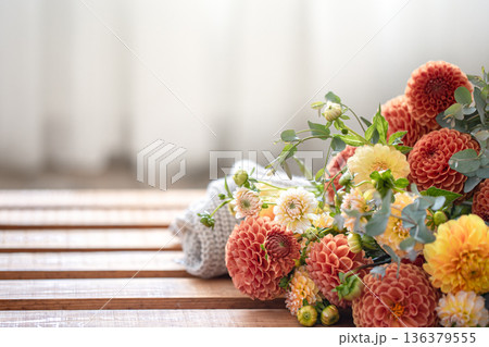 A bouquet of yellow and orange chrysanthemums on a blurred background. A bouquet of yellow and orange chrysanthemums on a blurred background. 136379555