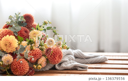 A bouquet of yellow and orange chrysanthemums on a blurred background. A bouquet of yellow and orange chrysanthemums on a blurred background. 136379556