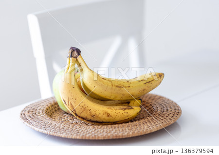 A bunch of ripe bananas in a bright kitchen interior. A bunch of ripe bananas in a bright kitchen interior. 136379594