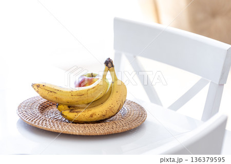 A bunch of ripe bananas in a bright kitchen interior. 136379595