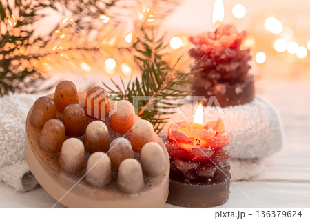 Christmas spa composition with incense sticks and soap on a blurred background. Christmas spa composition with incense sticks and soap on a blurred background. 136379624