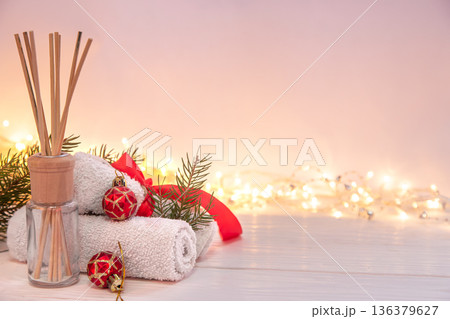 Christmas spa composition with incense sticks, towels and decor details. Christmas spa composition with incense sticks, towels and decor details. 136379627