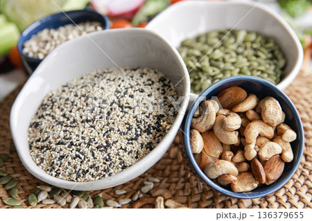 Close-up, a bowl of chia seeds and other healthy foods on the kitchen table. 136379655