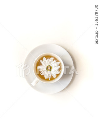 Close-up tea with chamomile flower isolated on white. Close-up tea with chamomile flower isolated on white. 136379730