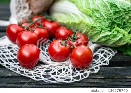 Close-up of tomatoes on a wooden surface. 136379740