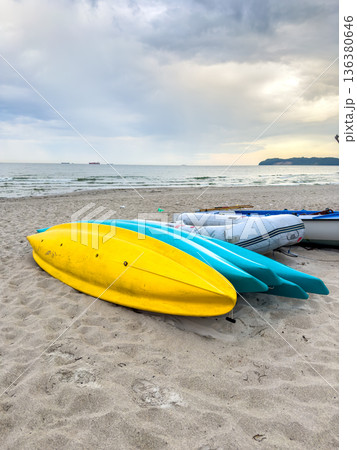 Tourist boats on an empty sandy beach. 136380646