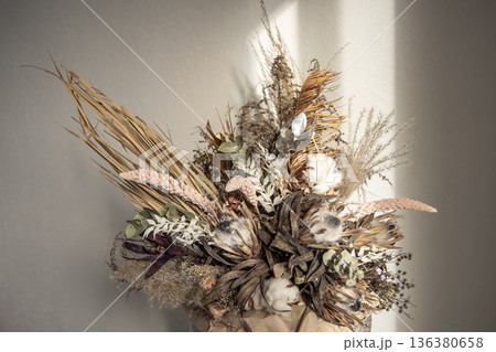 A bouquet of dried flowers as a detail of home interior design close up. A bouquet of dried flowers as a detail of home interior design close up. 136380658
