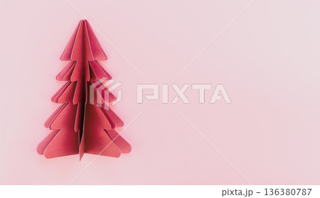 A pink paper origami christmas tree on pink background isolated, copy space. 136380787