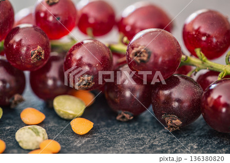 Red currant berries on a textured surface, macro shot. 136380820