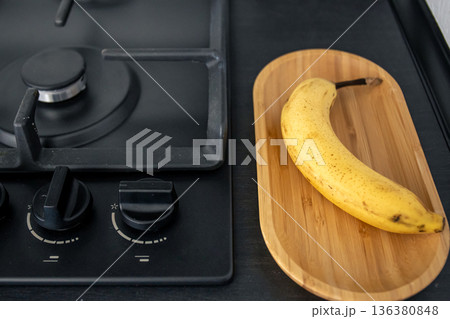 Ripe yellow banana in the kitchen near the sink. Ripe yellow banana in the kitchen near the sink. 136380848
