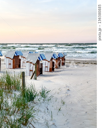 Sandy beach by the sea with dressing rooms. Sandy beach by the sea with dressing rooms. 136380885