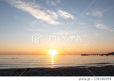 Sea embankment at sunset with a clear cloudless sky. 136380894
