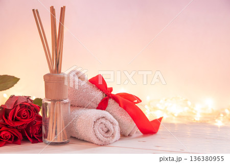 Spa composition for Valentine's Day with incense sticks, towel and red roses. 136380955
